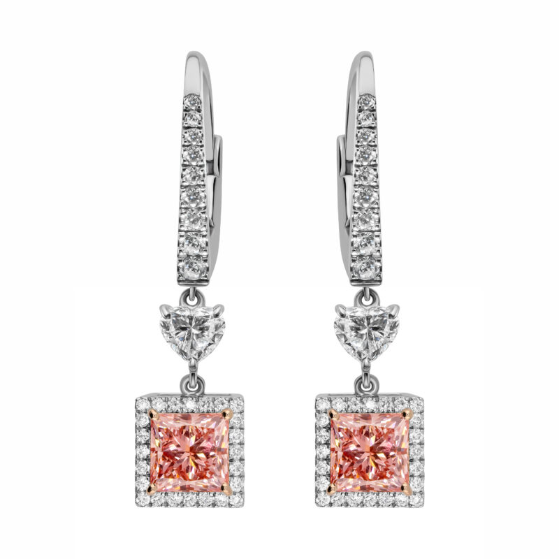 Pink diamond earrings featuring princess cut vivid pink diamonds, halo of diamonds, heart-cut diamond connector and lever-back mechanism