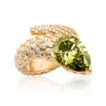 A pear cut vivid green diamond snake ring crafted in yellow gold with scales accented by round cut white diamonds