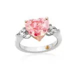 Pink diamond engagement ring with a heart-cut ceterstone gem and two pear-shaped diamonds on the sides