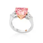 Pink diamond ring is crafted with a heart cut vivid pink diamond as a centerstone and two pear-shaped side diamonds