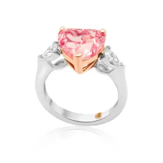 Pink diamond ring is crafted with a heart cut vivid pink diamond as a centerstone and two pear-shaped side diamonds