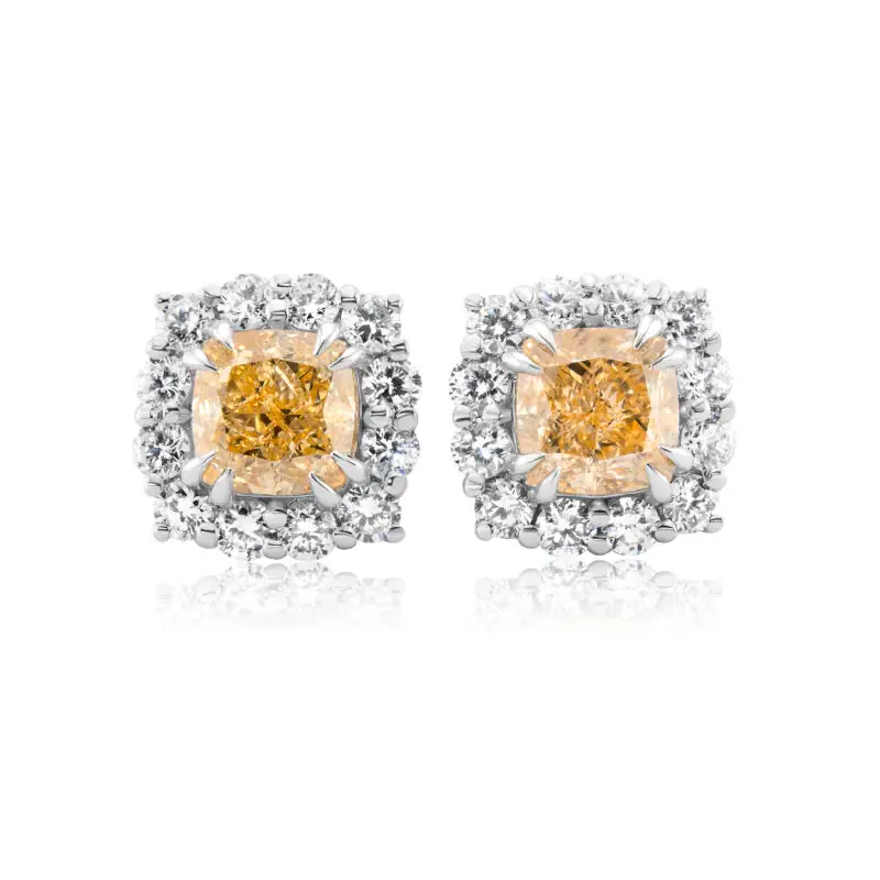 White gold studs with yellow diamonds. Center stones are intense yellow diamonds each surrounded by a halo of white round-cut diamonds.