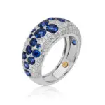 Sapphire dome ring crafted in white gold featuring round cut diamonds and royal blue sapphires